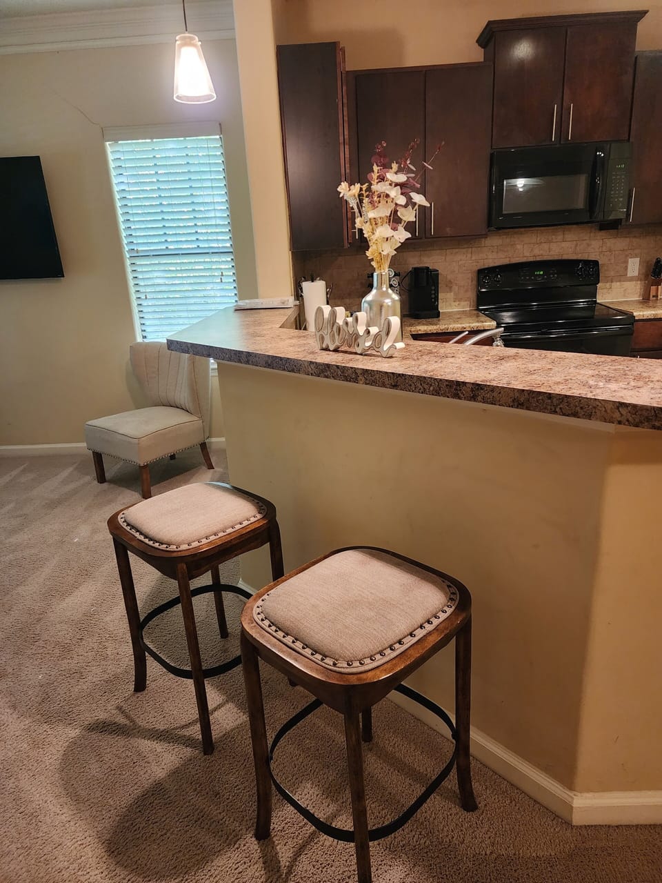 2 bar stools in front of kitchen counter