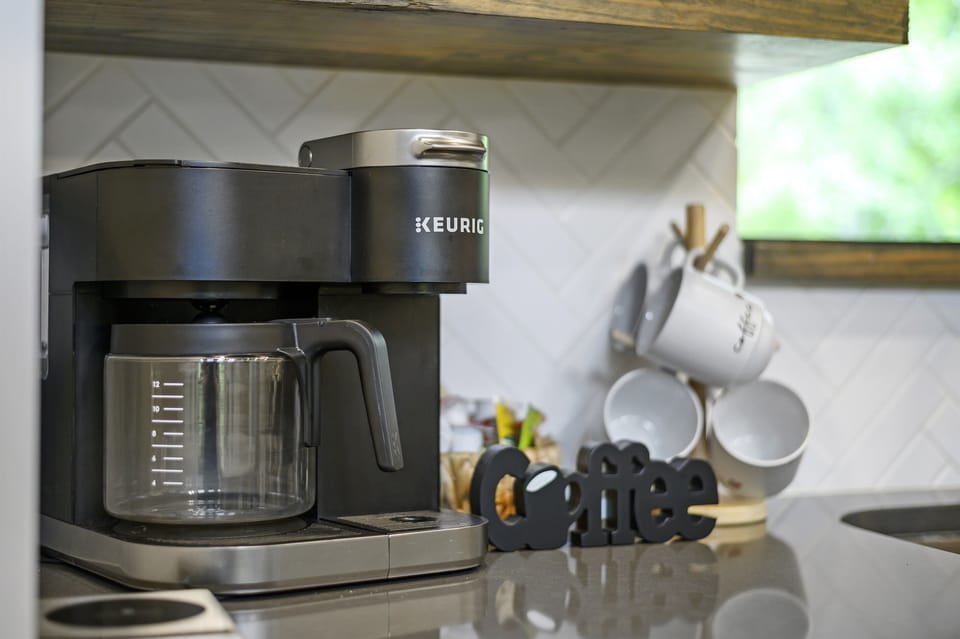 Wake up with fresh coffee from our premium machine—perfect for slow mornings in your modern cabin.