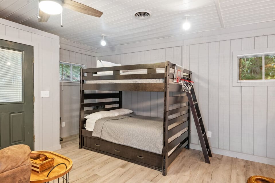 The full bunk beds are located in the game room,  that is separate from the main home.  To access,  you will walk out of the doors in the laundry area to the covered porch.  walk down the steps to the game room door.  The code to this door will be the sam
