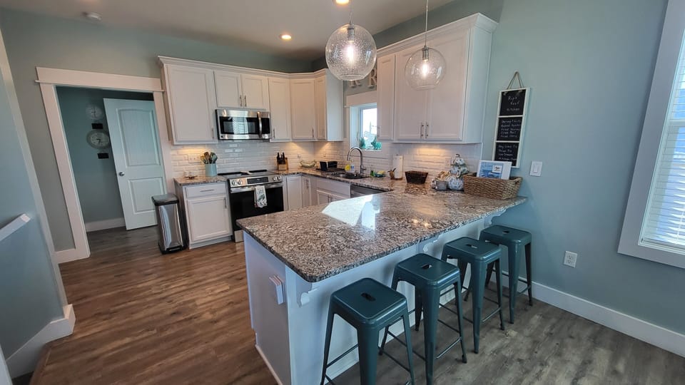 lovely fully equipped kitchen with additional seating at the bar.