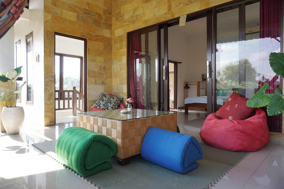 A balcony with hammock to relax overlooking the village and the lush garden