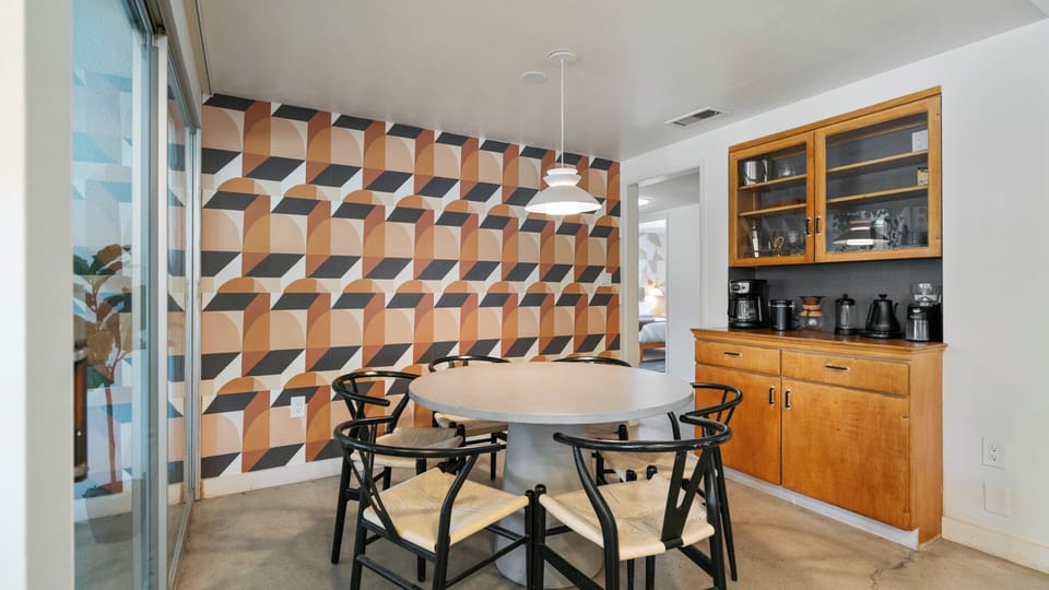 Stylish dining nook with bold accent wall and bright natural light