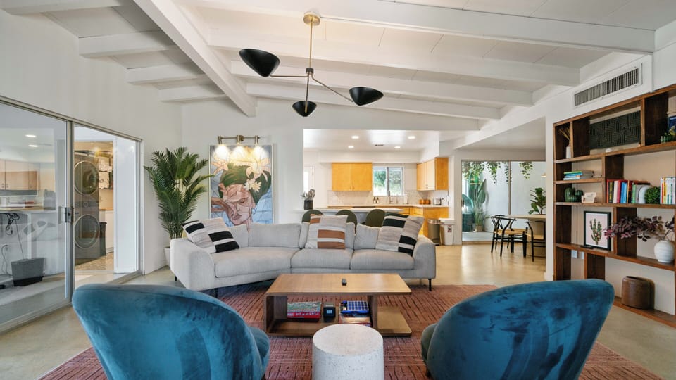 Bright open living space with designer seating and easy kitchen flow