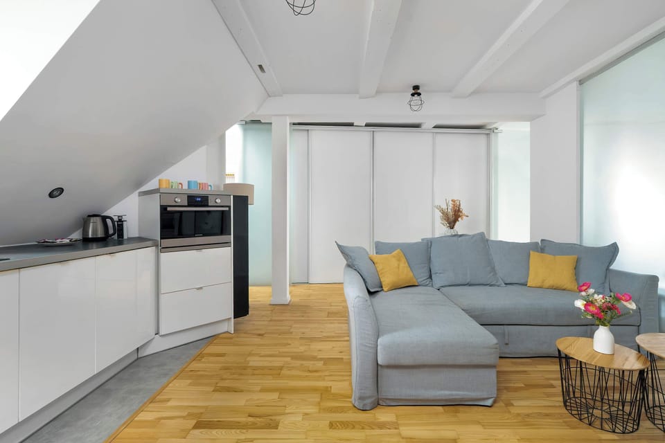 Living room with a comfortable sofa with mustard-yellow cushions and natural accents creates an inviting place to relax.