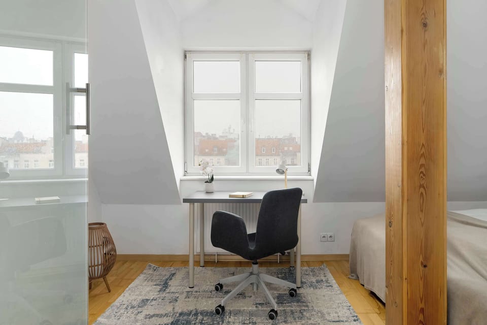 A bright desk area by the window, perfect for working or reading in natural light.