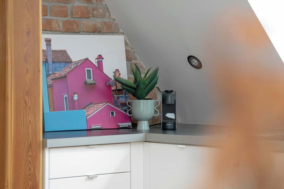 A colorful piece of artwork brightens the room, giving the living space a vibrant and creative flair.