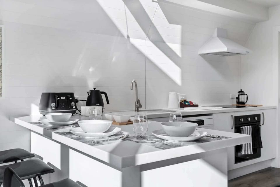 Bright modern kitchen with breakfast bar and dining setup