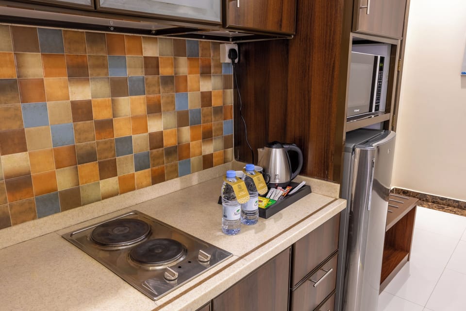 Mini-fridge, microwave, stovetop, cookware/dishes/utensils