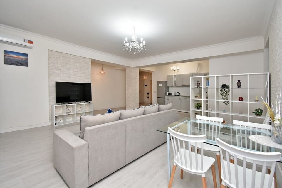 Deluxe Apartment, City View | Living area | 50-inch flat-screen TV with cable channels
