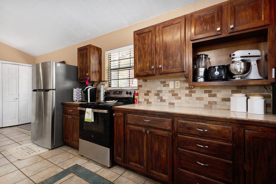 Whip up meals effortlessly in this fully stocked kitchen, featuring a blender, mixer, toaster, and all the essentials.