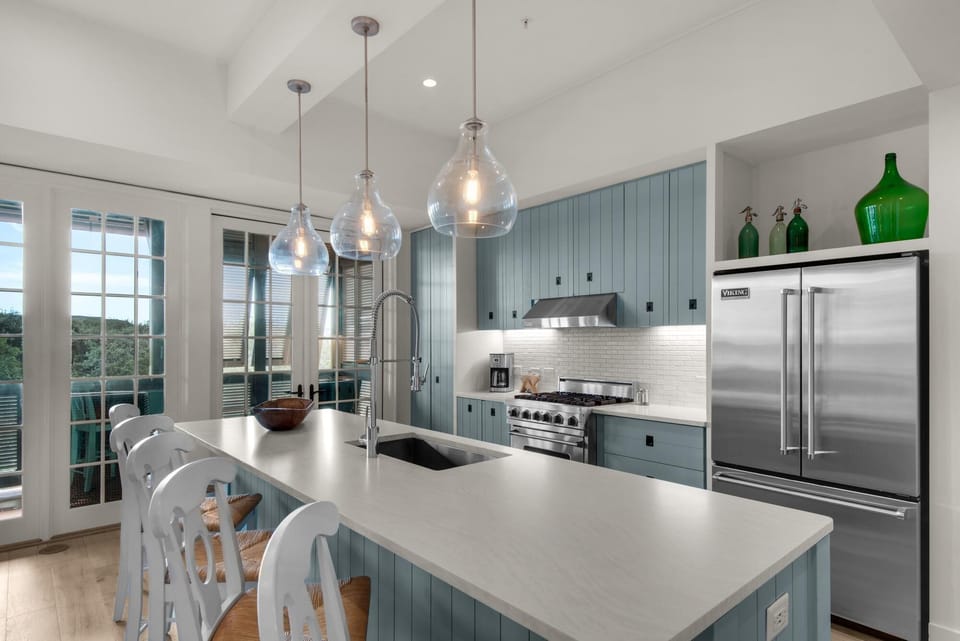 Modern kitchen with sleek appliances and bright island seating