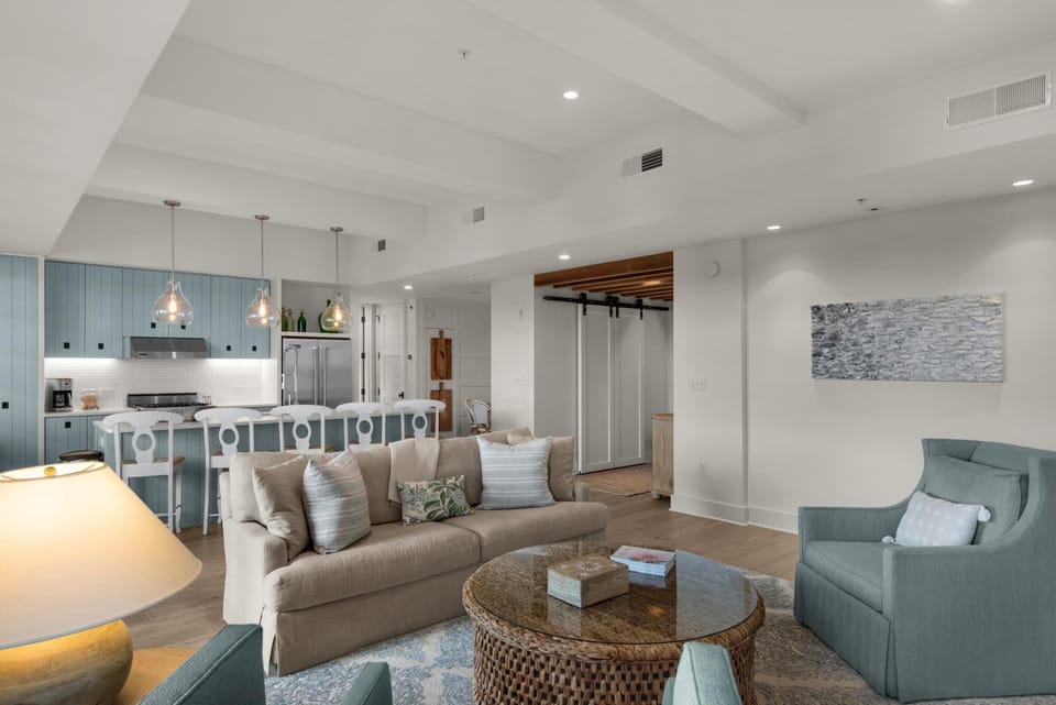 Spacious open living area with cozy seating and modern kitchen