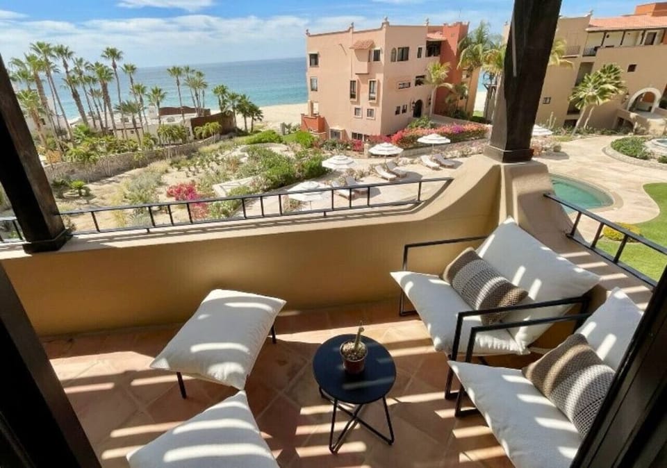 Lounge chairs on terrace – Relax with panoramic sea and resort views.
