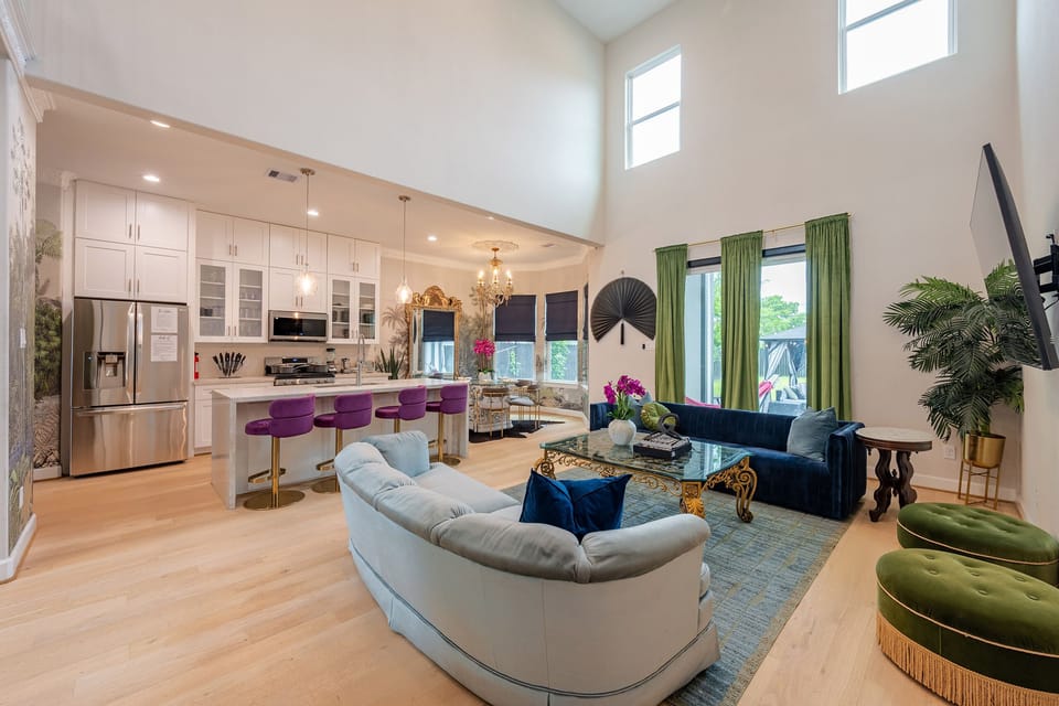 Stylish open living space with soaring ceilings and a sleek chef’s kitchen