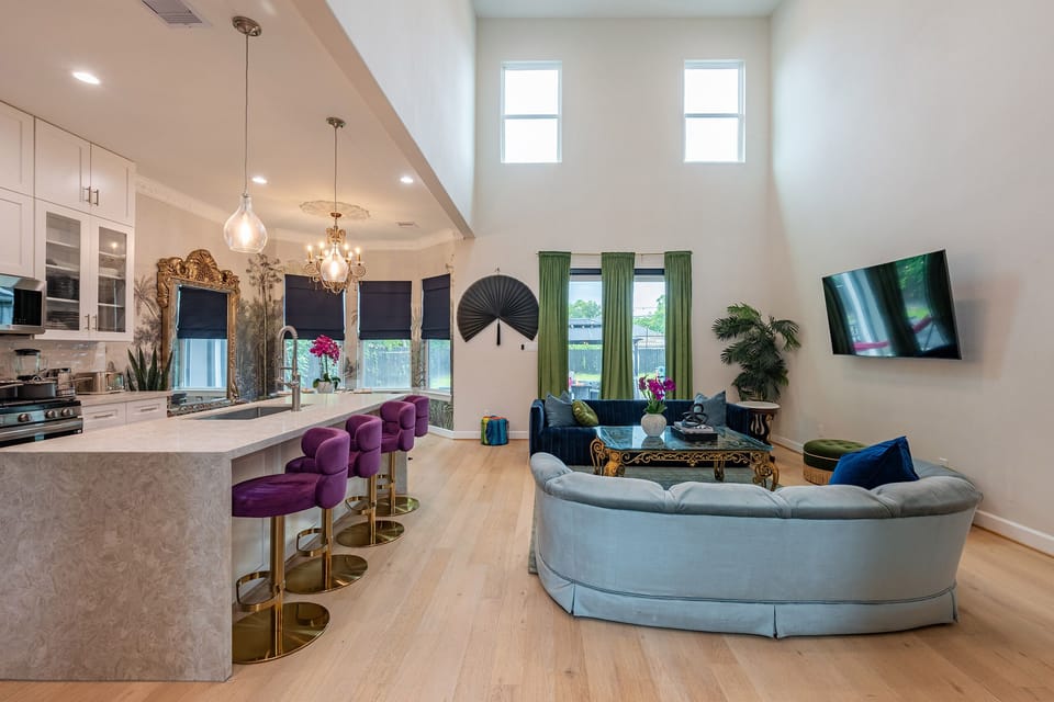 Bright open-concept lounge and kitchen with soaring ceilings