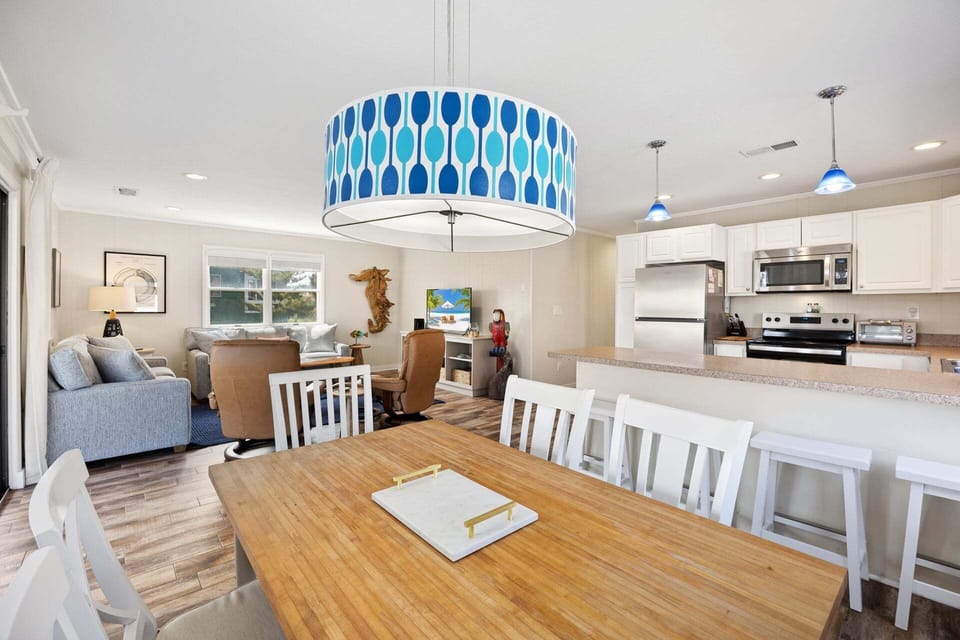 Gather around the dining table that seats 4–6 for family meals, games, or planning the next beach adventure.