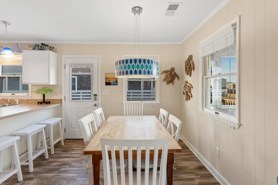 Gather around the dining table that seats 4–6 for family meals, games, or planning the next beach adventure.