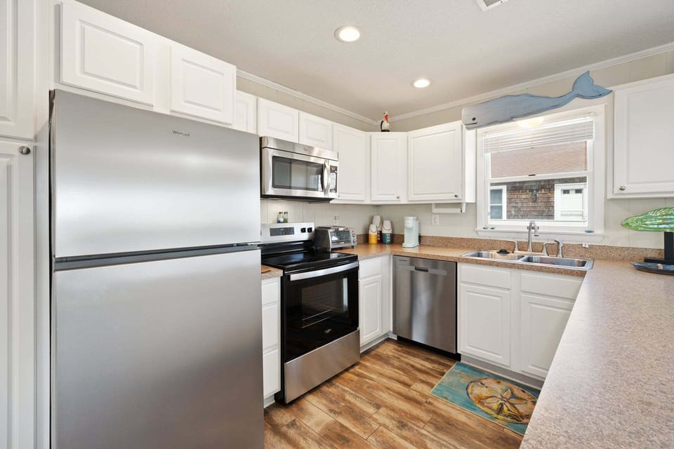 Fully equipped kitchen with modern appliances, a breakfast bar for 3, and everything you need to prepare delicious meals at home.