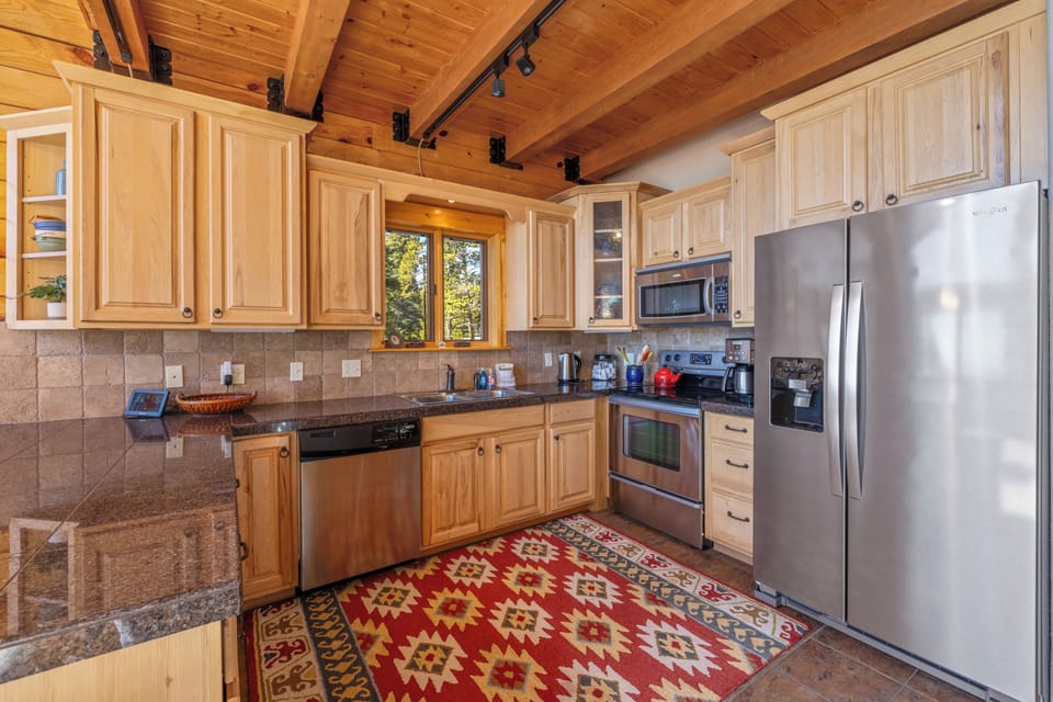 Kitchen is fully stocked with dishes, cooking gadgets, and baking accessories.