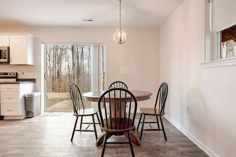 Dining area with seating for four and patio doors to the backyard