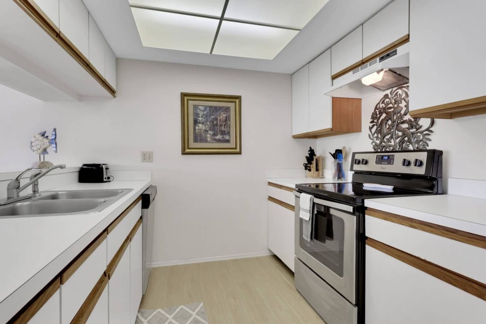 The galley-style kitchen has a smooth-top oven, refrigerator/freezer, dishwasher and microwave.