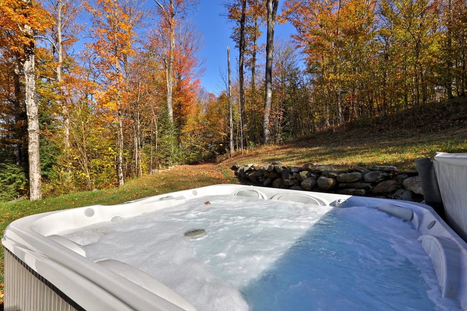 Take in the wooded hillside from the deck hot tub, framed here by fall color.
