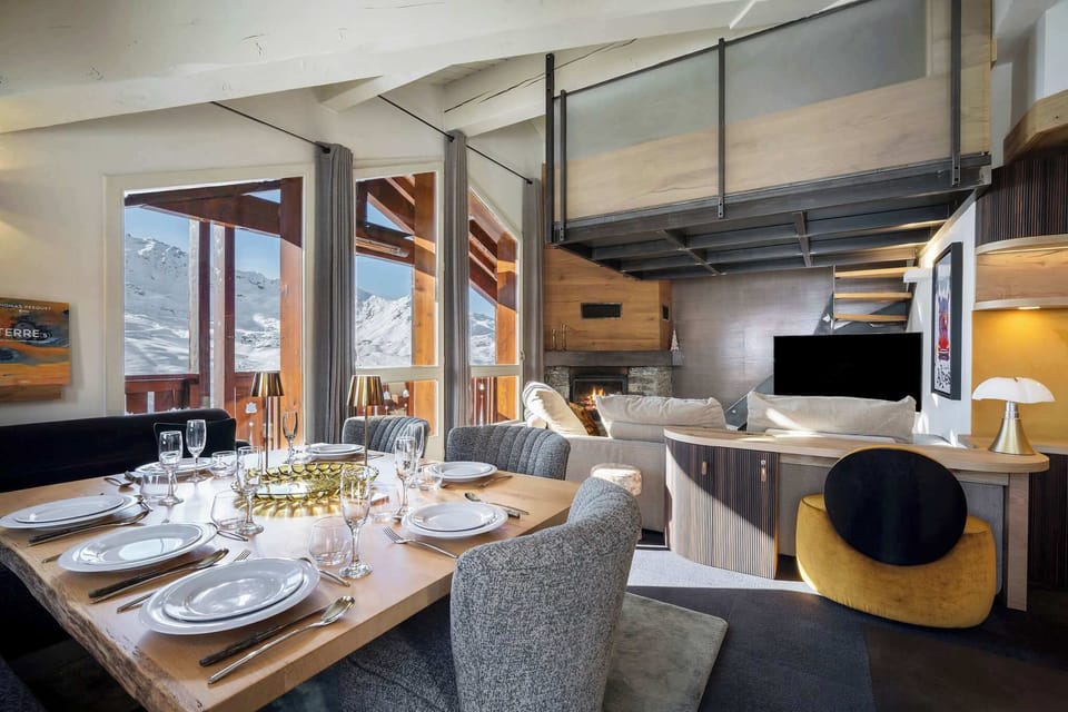 Stylish modern-alpine kitchen in our Val Thorens apartment— coffee machine, oven, microwave, stove and dining island, perfect after-ski dinners.