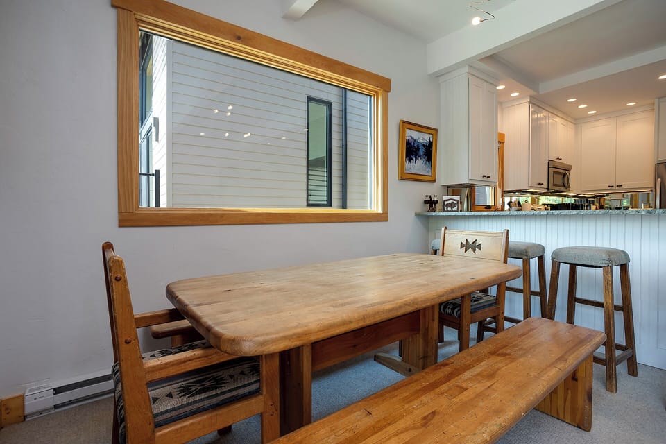 Gather around this warm wooden dining table for memorable meals with your group in this bright, open-plan space.