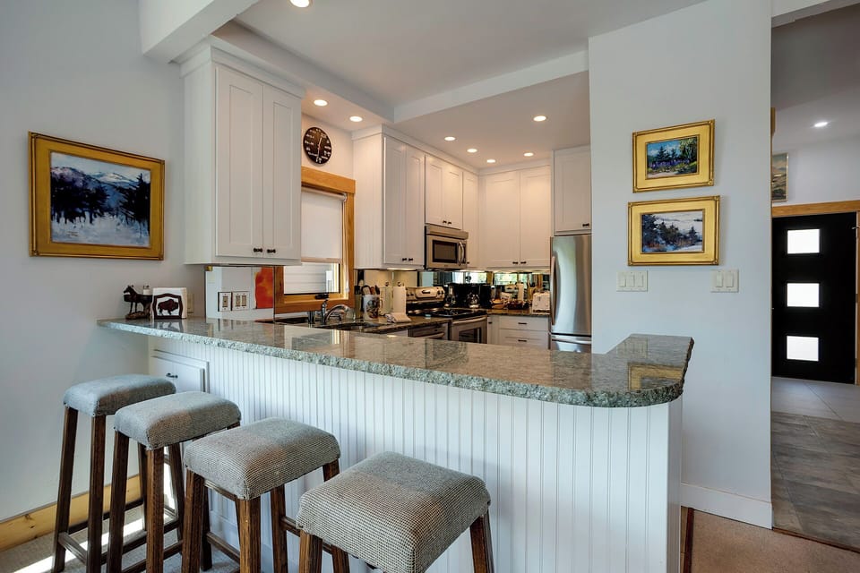 Your gourmet kitchen awaits with granite counters, stainless appliances, and cozy breakfast bar seating for morning coffee conversations.