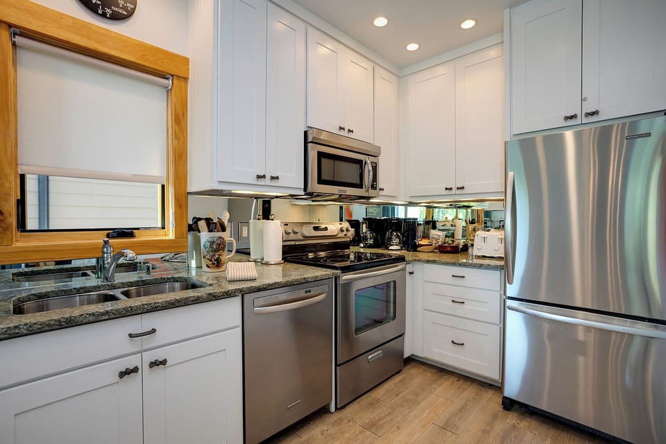 Your fully equipped kitchen awaits with gleaming granite counters, stainless appliances, and everything needed to create memorable meals during your stay.