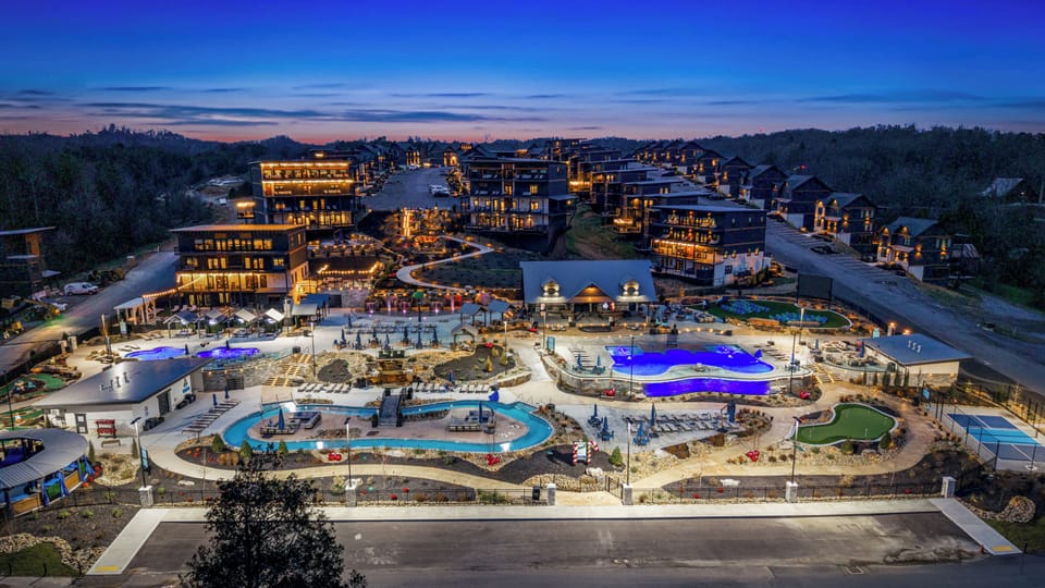 Smith Creek reserve resort at twilight. Lazy River, Infinity Pool, Mini Golf (Putt Putt Golf), Pickle ball court, Putting Green, Clubhouse, Pool Table, Ping Pong, Splash Pad, Waterfall, Splash Pad, Cabanas, Private Resort free to guests.