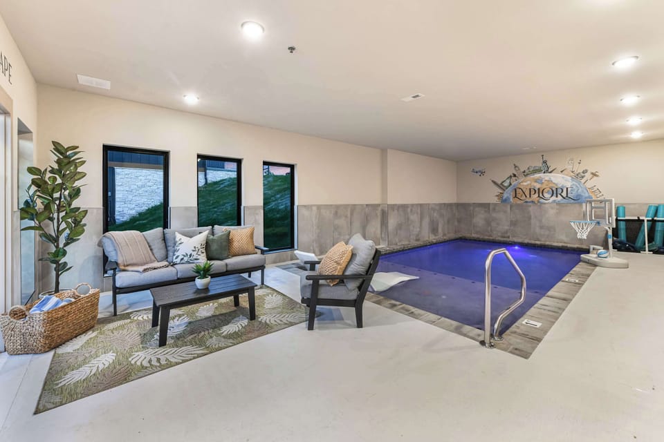 Indoor pool area with seating and a playful basketball hoop for family-friendly fun.