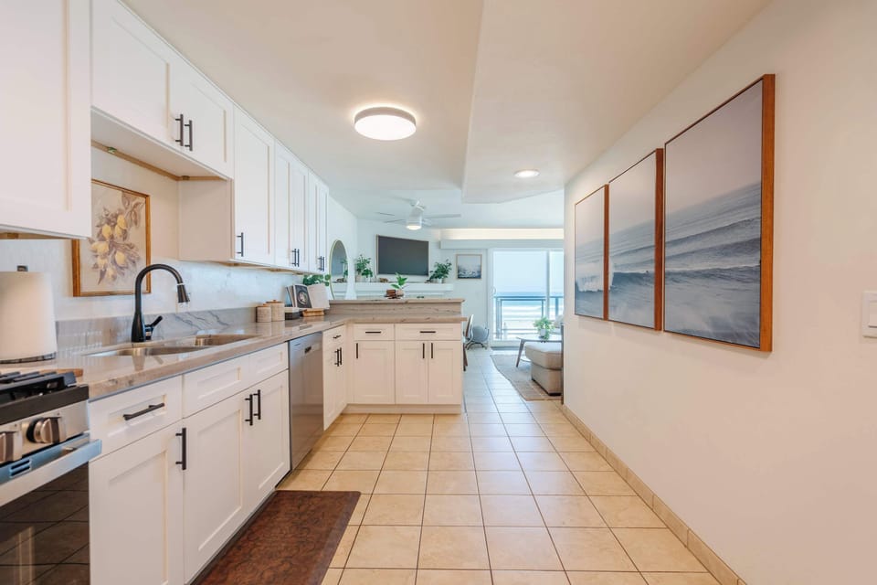 Fully equipped kitchen with modern appliances and beachy charm.