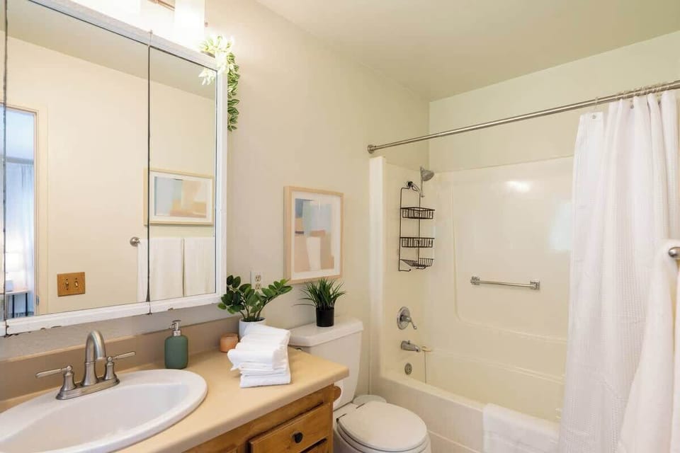 The master bathroom features a relaxing full size tub with an overhead shower 