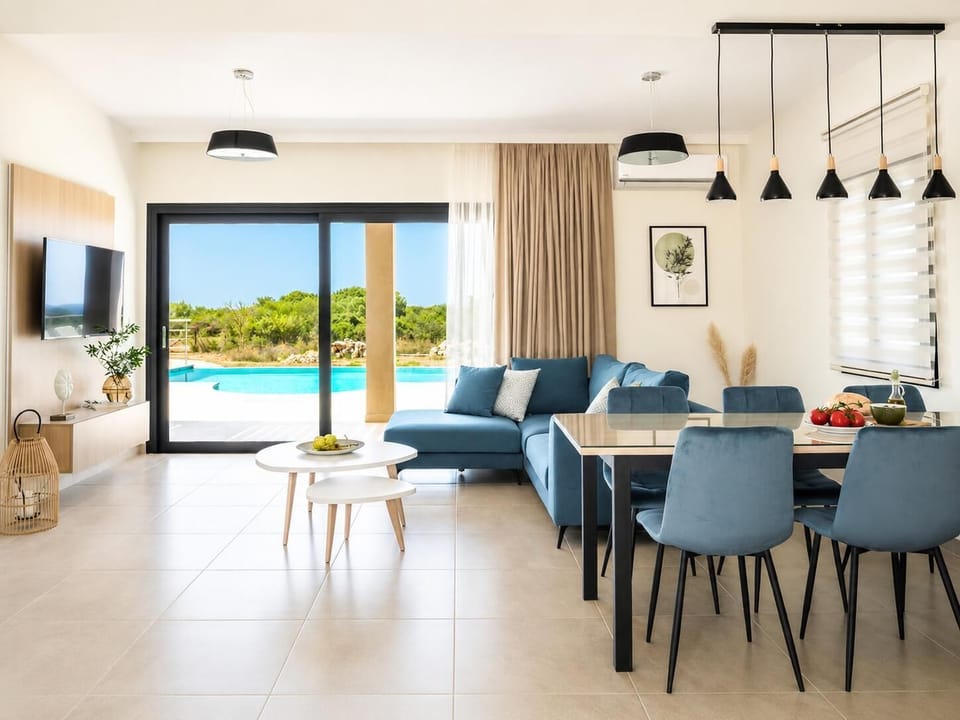 Living room with sofa, dining area, kitchen, A/C, WiFi internet, satellite TV, and sea views