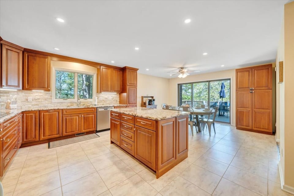 Cook family meals in the upgraded, well-stocked kitchen with ample granite counter space