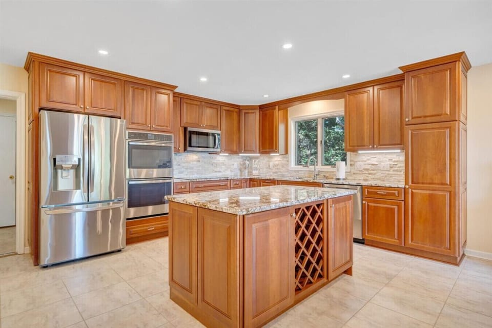 Cook family meals in the upgraded, well-stocked kitchen with ample granite counter space