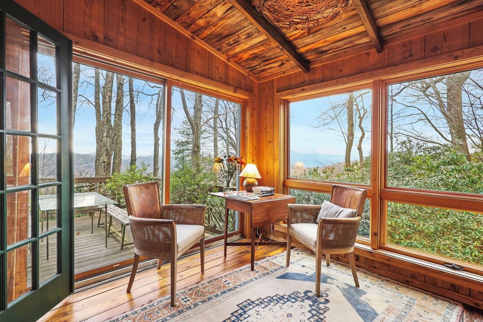 Light filled sunroom with floor to ceiling windows framing stunning Mt. Views