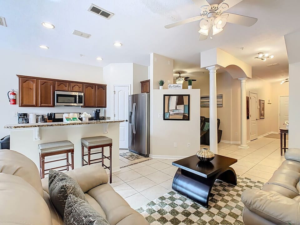 Fully equipped kitchen with granite counters, bar seating, and modern appliances for a convenient home-away-from-home experience.