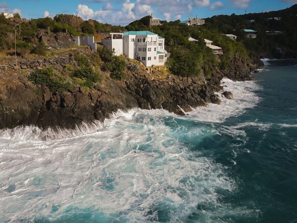 Waves crash just below the home.