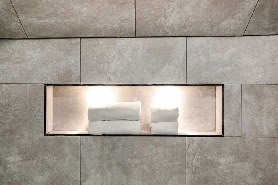 Rainfall shower with built-in niche shelving.