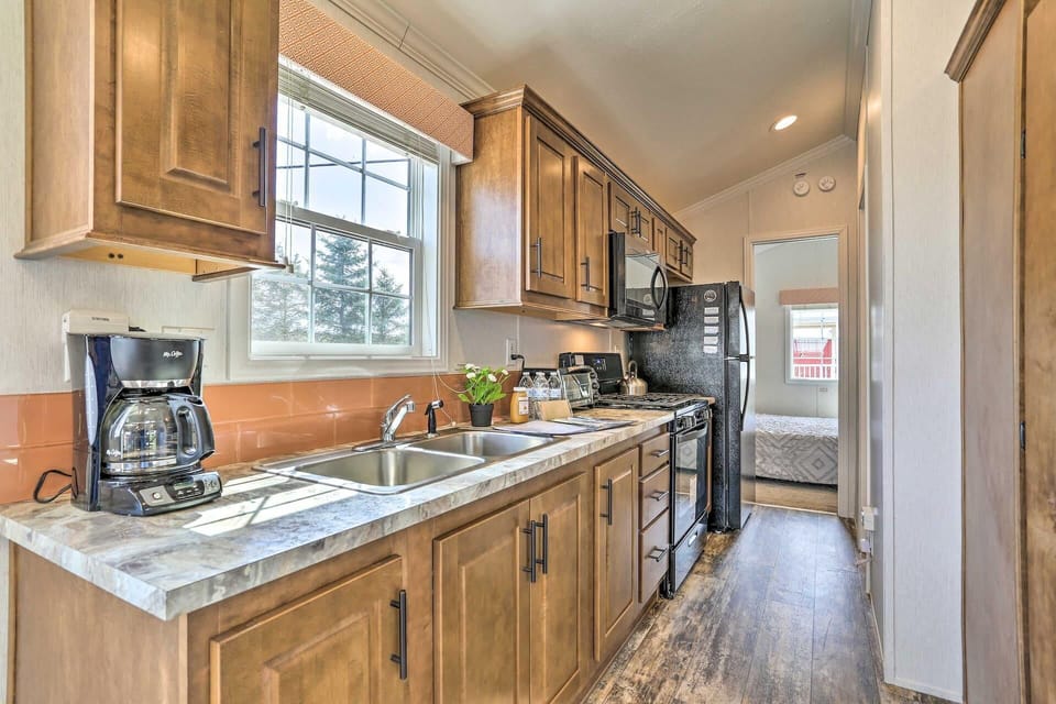 Bright, cozy kitchen with rustic wood cabinets and modern appliances