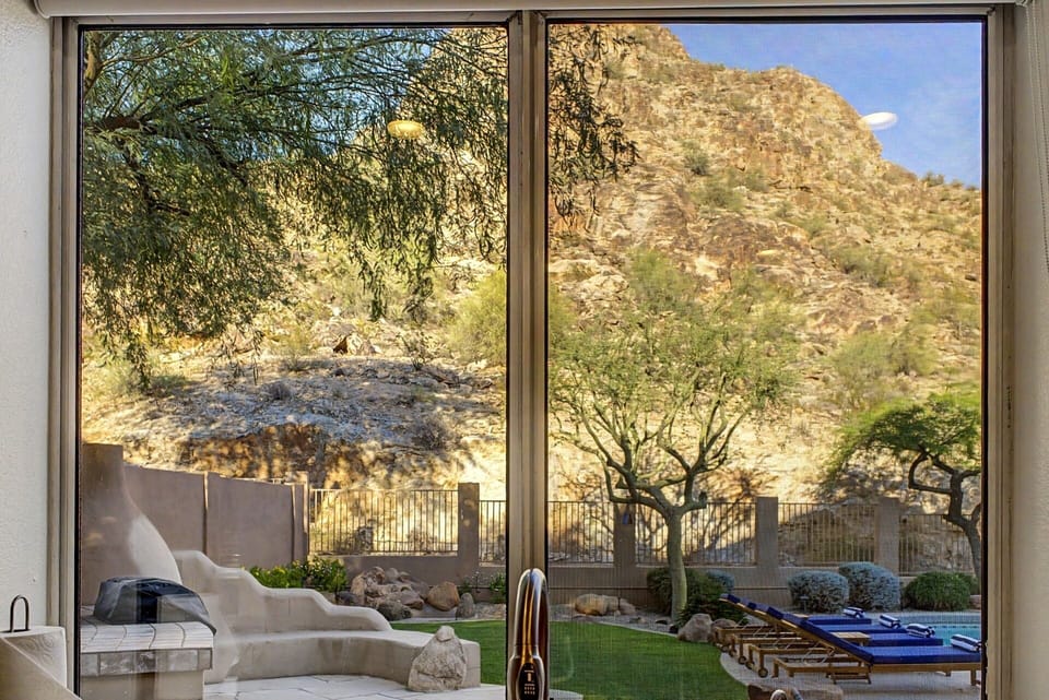 Amazing Kitchen View: Marvel at stunning mountain vistas and the backyard while prepping meals in style!