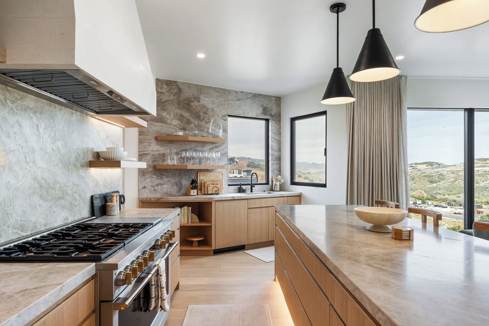 Beautifully designed gourmet kitchen with professional-grade appliances, a spacious island, and stunning stone accents.