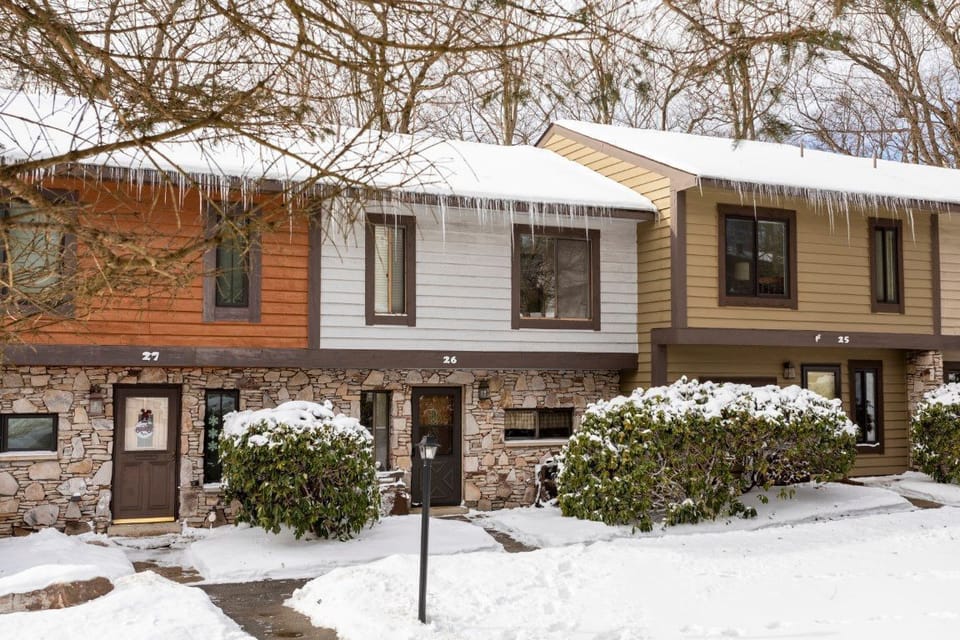 Charming exterior sets the tone for your mountain getaway, framed by natural beauty in every season.