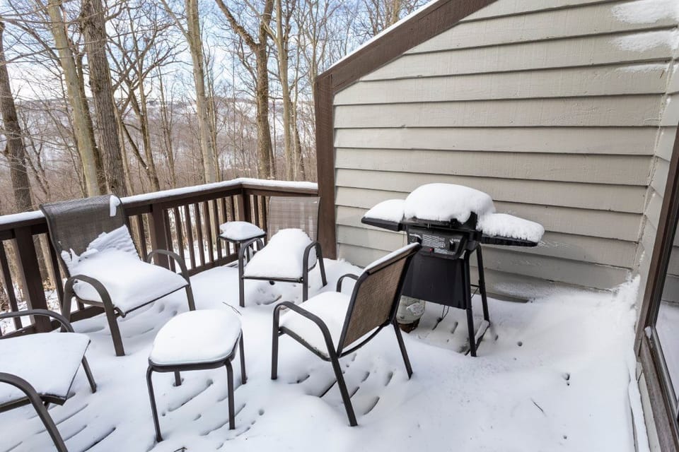 Snow-dusted balcony with grill invites you to savor crisp mountain air, no matter the time of year.