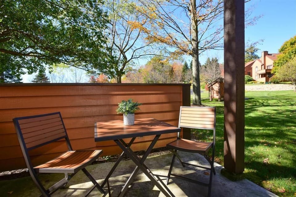 Peaceful outdoor patio surrounded by greenery, offering a quiet spot to soak in the fresh mountain air.