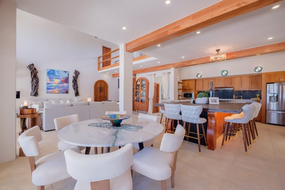 The open dining room flows seamlessly into the living area and oceanview kitchen, creating a spacious, light-filled setting for shared meals and gatherings. Thoughtful design details and comfortable seating make this space ideal for entertaining.