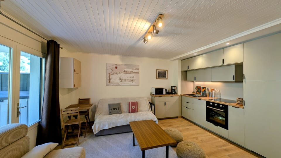 Open-plan living and dining area with a warm alpine style, perfect for relaxing after a day on the pistes.