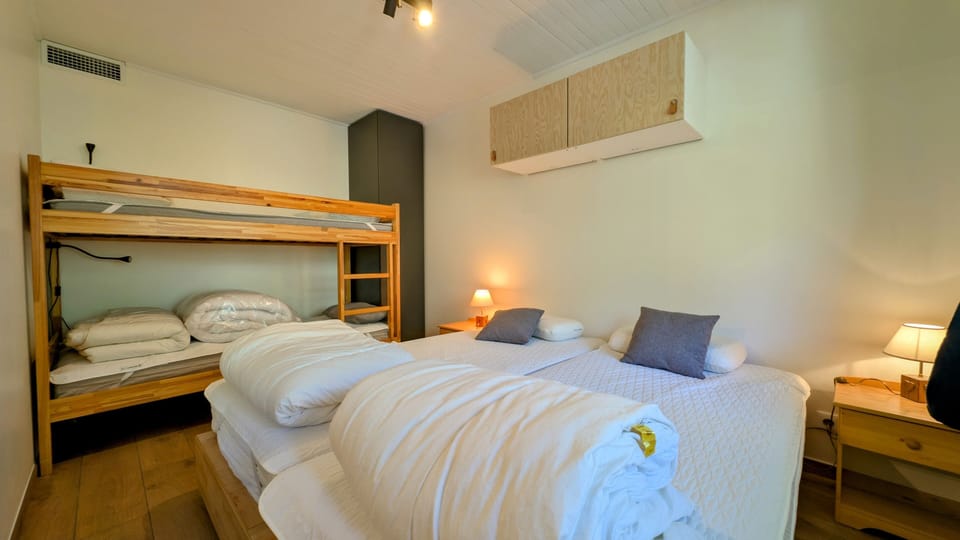 Family-friendly second bedroom with a double bed and bunk beds — ideal for kids or friends sharing.